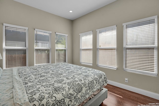 bedroom with dark wood-type flooring