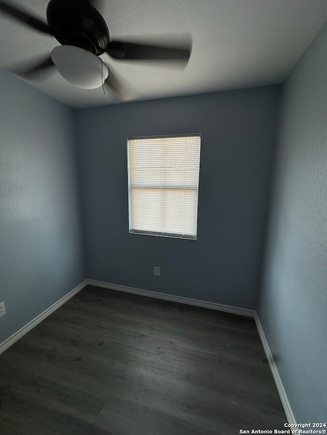 spare room featuring ceiling fan and dark hardwood / wood-style flooring