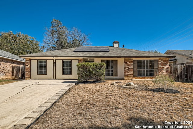 view of front of home featuring solar panels