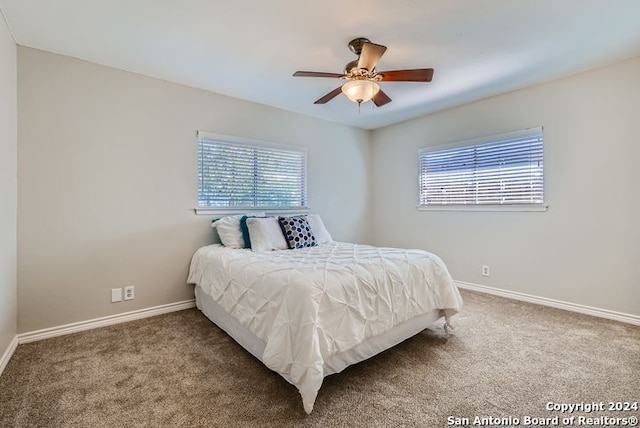 bedroom with carpet, multiple windows, and ceiling fan