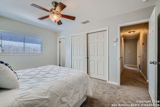 carpeted bedroom featuring a closet and ceiling fan