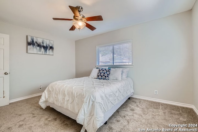 bedroom featuring light colored carpet and ceiling fan