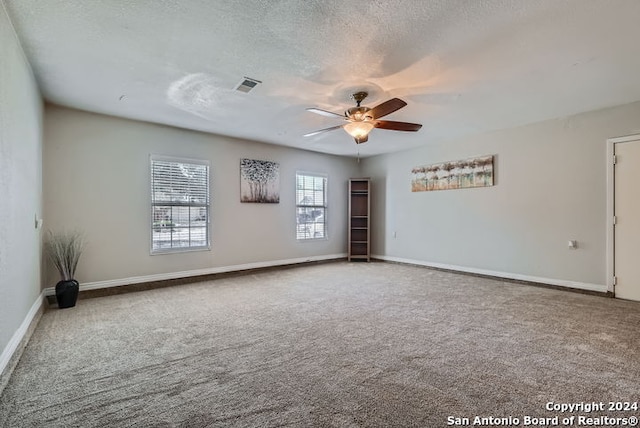 unfurnished room featuring ceiling fan, a textured ceiling, and carpet floors