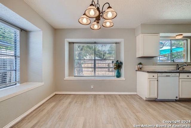 kitchen with dishwasher, sink, a notable chandelier, light wood-type flooring, and white cabinetry