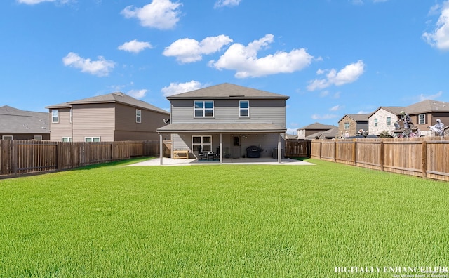 rear view of property featuring a patio and a yard