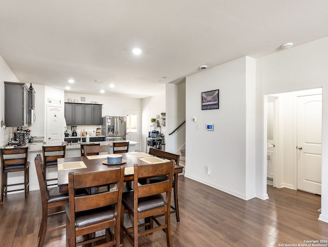 dining area featuring dark wood-type flooring