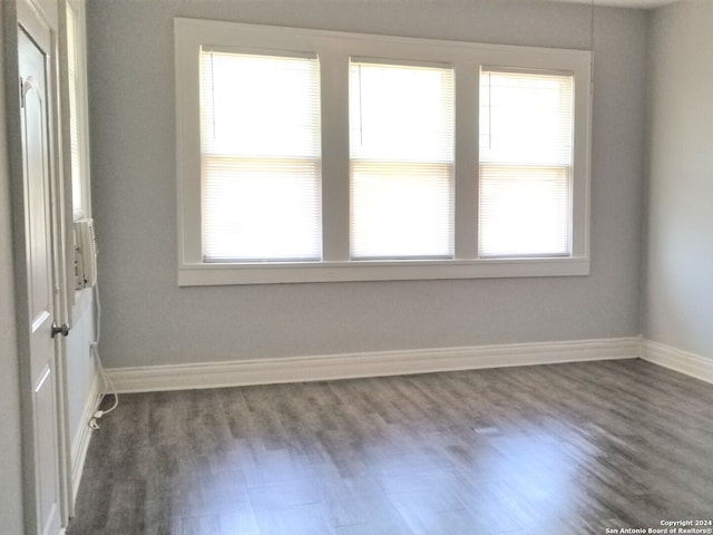 unfurnished room featuring dark hardwood / wood-style flooring