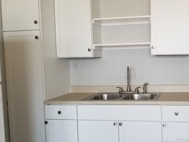 kitchen featuring sink, white cabinets, and tasteful backsplash