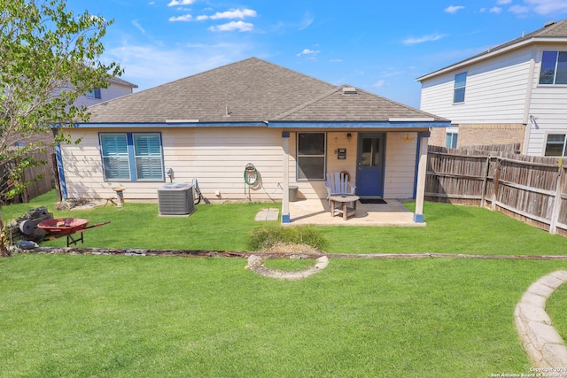 back of house with a patio, a shingled roof, and central AC unit