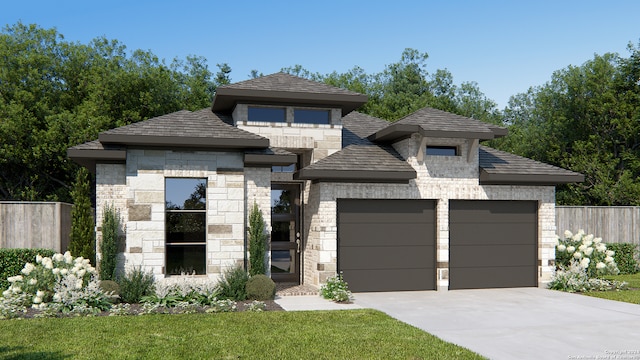 view of front of home with a front lawn and a garage