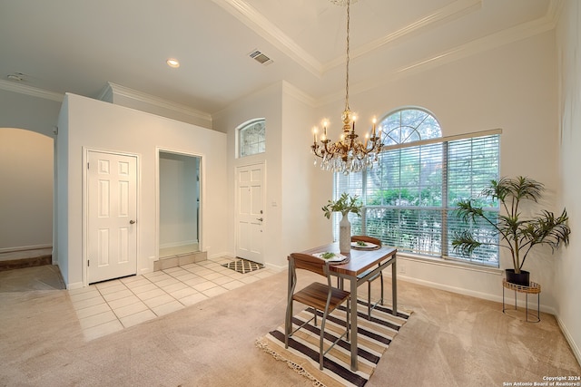 carpeted dining space featuring an inviting chandelier, crown molding, and a high ceiling