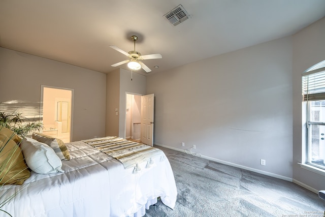 bedroom with ensuite bath, carpet, and ceiling fan