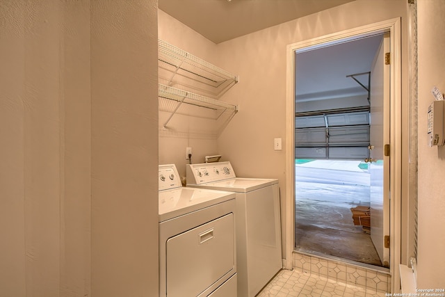 clothes washing area featuring independent washer and dryer and light tile patterned floors