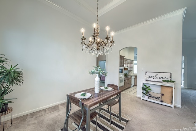 dining area featuring sink, light carpet, ornamental molding, and an inviting chandelier