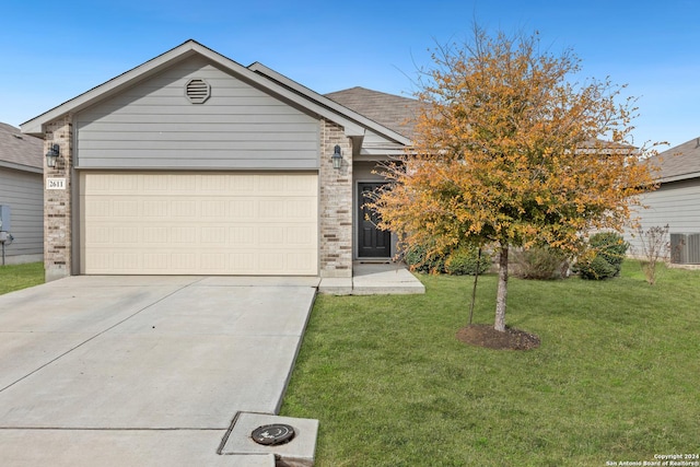 view of front of property with a front yard and a garage