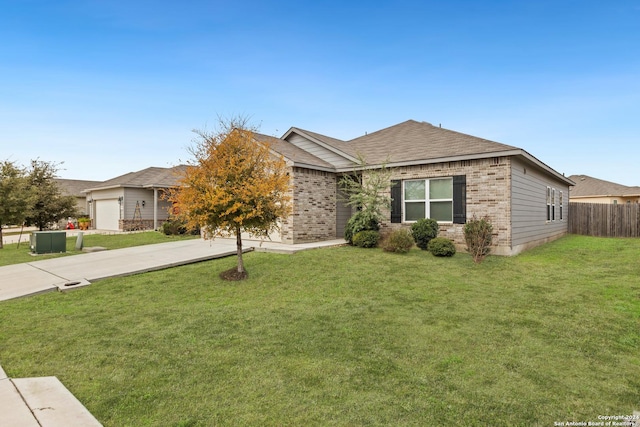 ranch-style house featuring a front yard and a garage