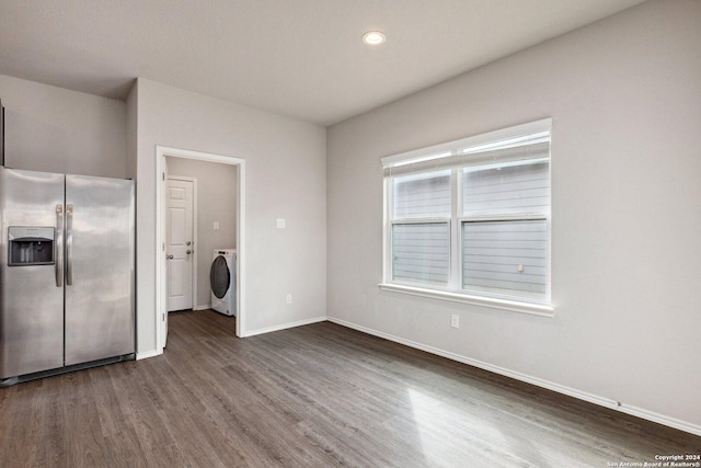 kitchen featuring stainless steel fridge with ice dispenser, dark hardwood / wood-style floors, and washer / dryer