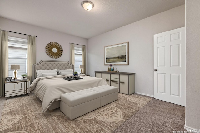 carpeted bedroom with multiple windows and a textured ceiling