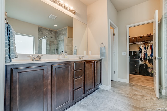 bathroom with vanity and a shower with shower door