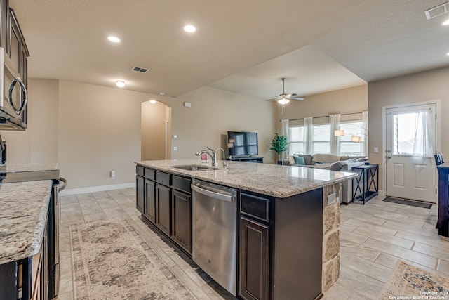 kitchen featuring sink, an island with sink, dark brown cabinetry, and stainless steel appliances