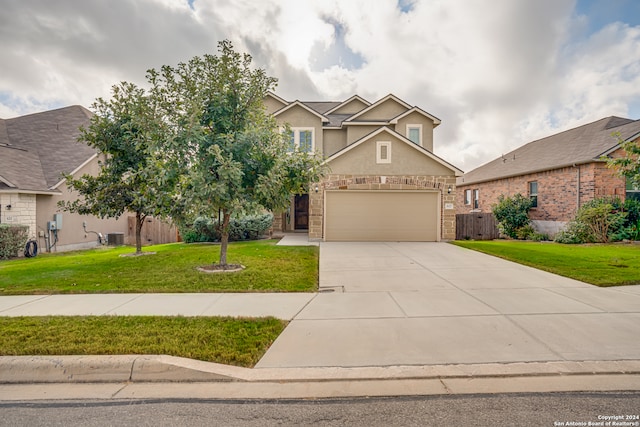 view of front of home with a front yard, central AC, and a garage