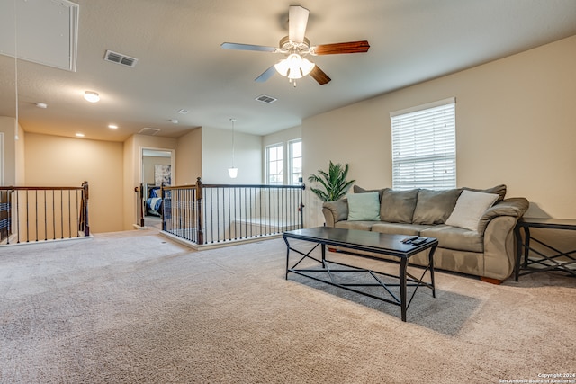 carpeted living room featuring ceiling fan