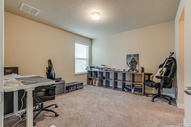 office area with carpet and a textured ceiling