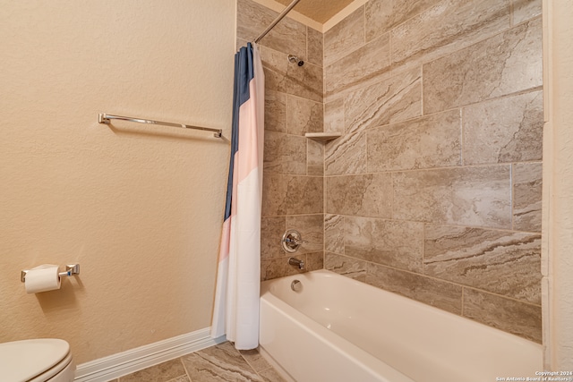 bathroom featuring toilet and shower / bath combo