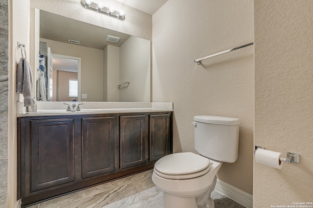 bathroom with toilet and vanity