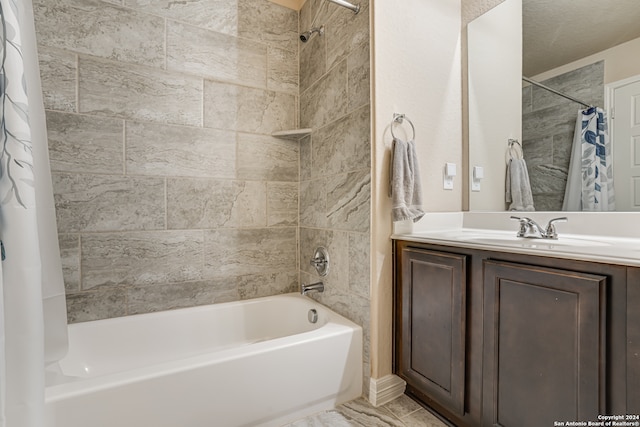 bathroom with vanity, a textured ceiling, and shower / bath combo