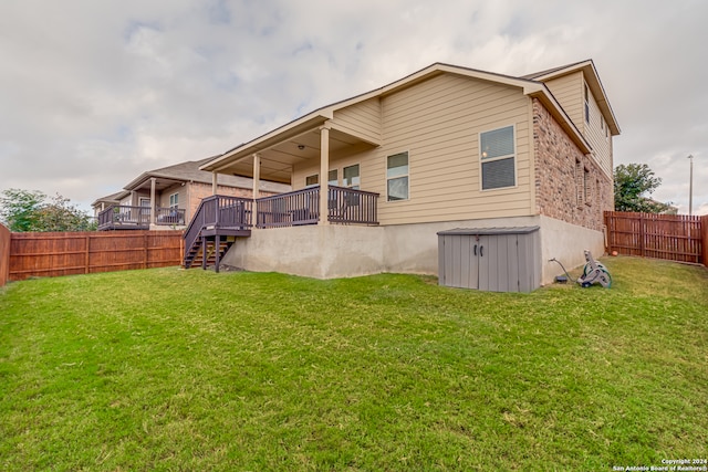 rear view of property with a deck and a lawn