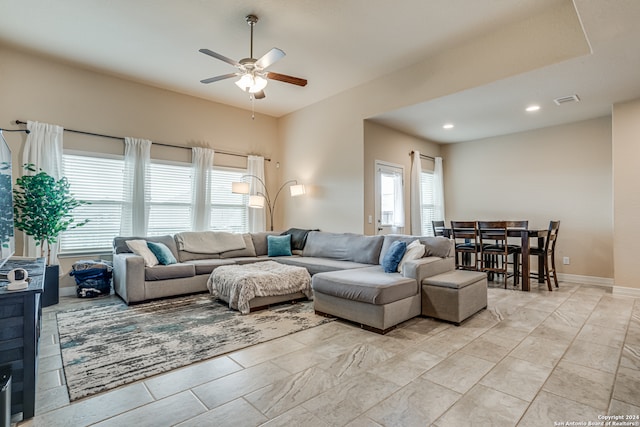 living room with plenty of natural light and ceiling fan