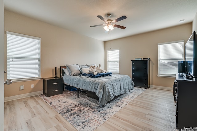 bedroom featuring light wood-type flooring and ceiling fan