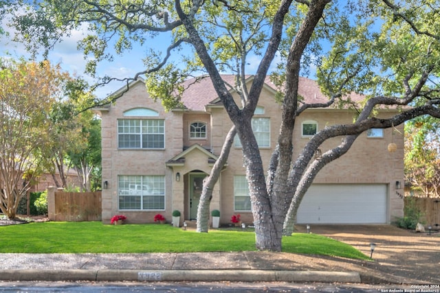 view of front of property featuring a front yard and a garage