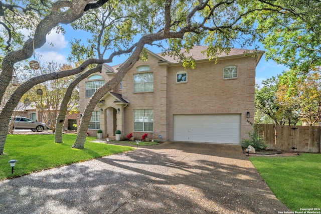 view of front of property featuring a front lawn and a garage