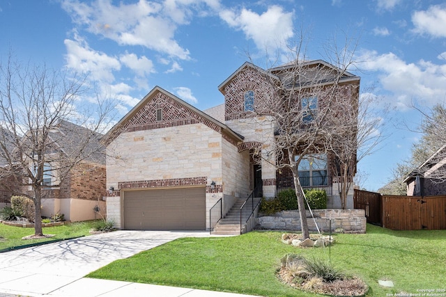 view of front facade with fence, an attached garage, stone siding, a front yard, and driveway