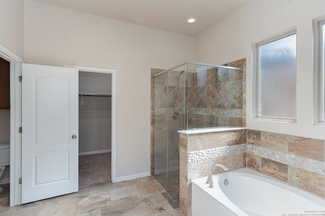 bathroom with a shower stall, recessed lighting, a garden tub, and a spacious closet