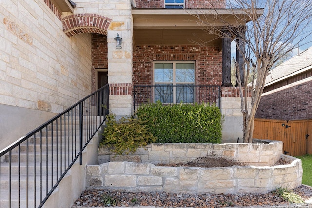 doorway to property featuring brick siding and stone siding