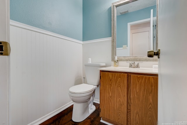 bathroom with vanity, toilet, and wood-type flooring