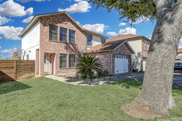 view of property with a front lawn and a garage