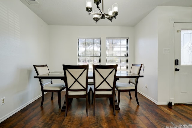 dining space featuring an inviting chandelier and dark hardwood / wood-style floors