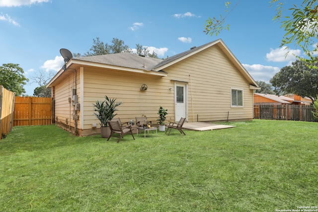 back of property with a patio and a lawn