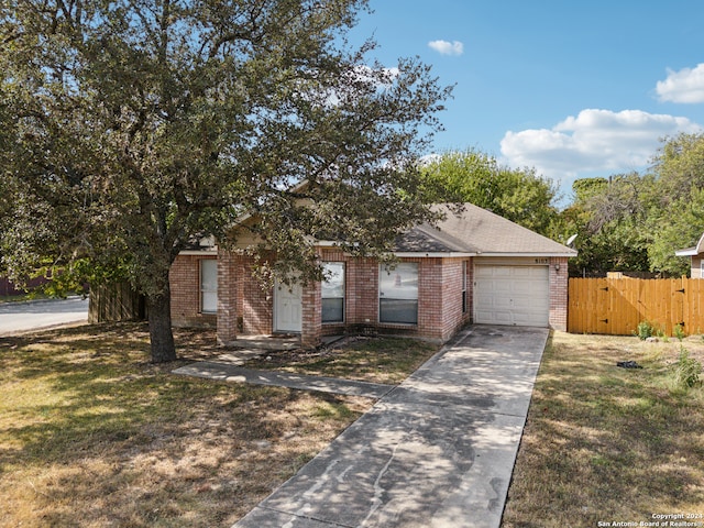 view of front facade with a front yard and a garage