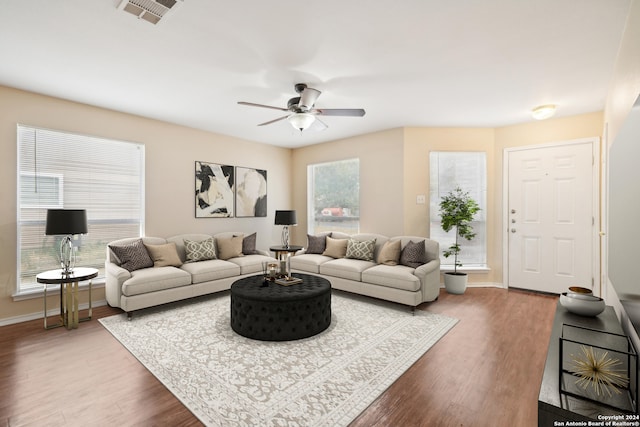 living room featuring hardwood / wood-style floors and ceiling fan