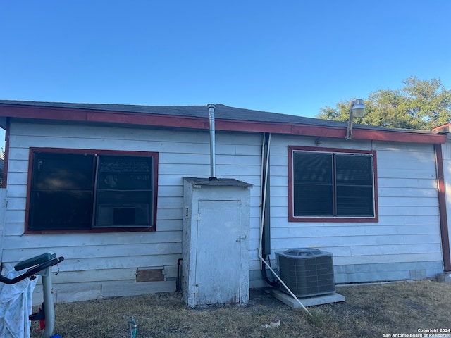 view of side of home featuring central AC