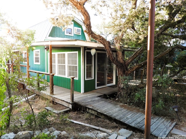 view of property exterior featuring a wooden deck and an AC wall unit