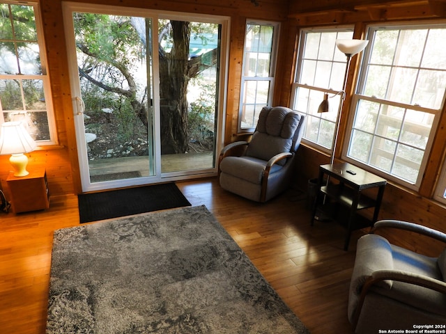 interior space with wood-type flooring and wood walls