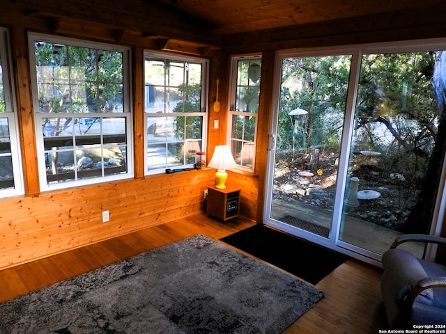 sunroom featuring wood ceiling and a wealth of natural light