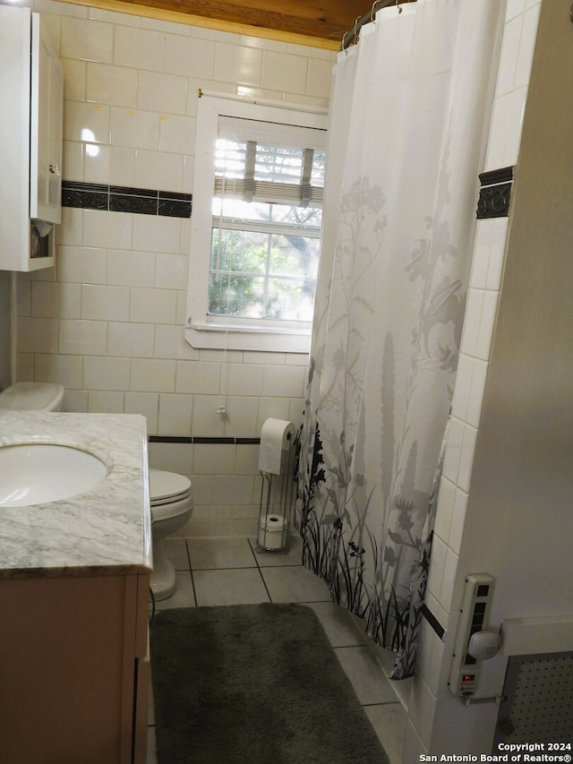 bathroom featuring toilet, tile patterned flooring, a shower with curtain, vanity, and tile walls