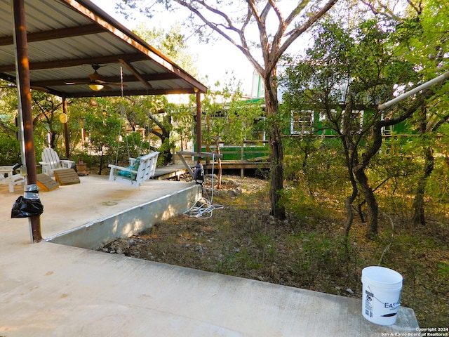 view of yard featuring a patio area and ceiling fan